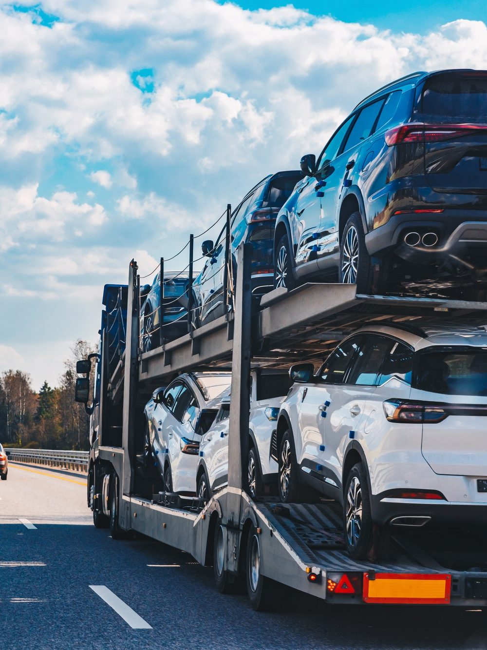 Car transport truck driving on highway road. Car Carrier Trailer on asphalt road